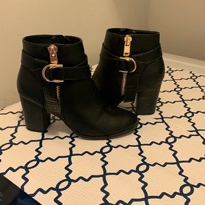 Black ankle boots with gold buckle